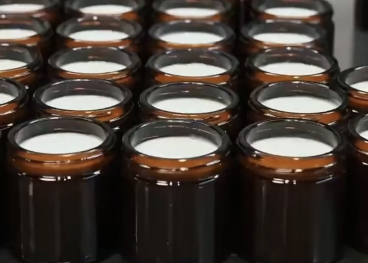 Hands filling a small batch by hand